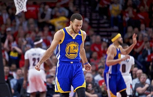 Golden State Warriors guard Stephen Curry reacts after making a basket against the Portland Trail Blazers during the second half of Game 3 of an NBA basketball first-round playoff series Saturday, April 22, 2017, in Portland, Ore.