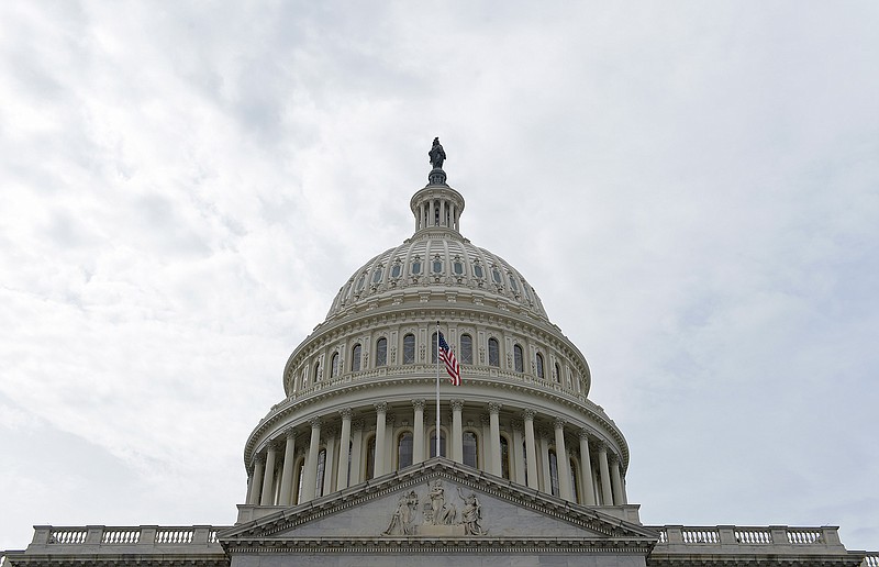 In this photo taken Feb. 28, 2017, a flag flies on Capitol Hill in Washington. Lawmakers return to Washington this week to a familiar quagmire on health care legislation and a budget deadline dramatized by the prospect of a protracted battle between President Donald Trump and congressional Democrats over his border wall. 