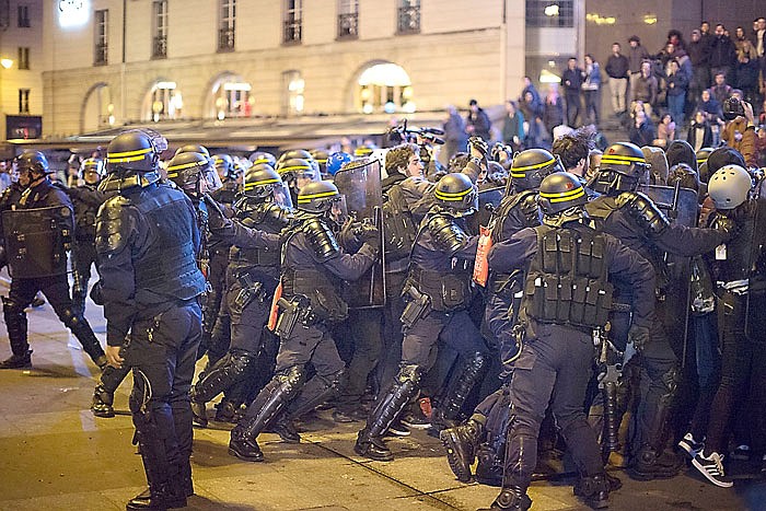 Protesters angry that far-right leader Marine Le Pen is advancing the French presidential runoff scuffle with police in Paris. 