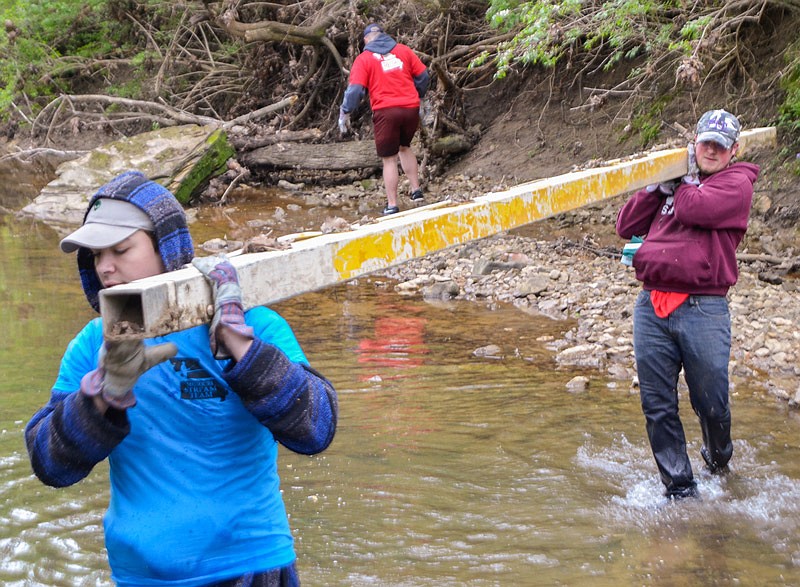 Quinton Sean, left, and Cody Mathews move a large metal pole Saturday, April 22, 2017 from Stinson Creek at the Fulton Clean Sweep event.