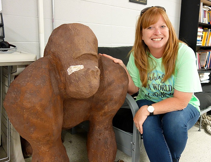 Special education teacher Janet Trowbridge pats her classroom gorilla in her Fulton High School classroom. The gorilla is a relic from a past homecoming, she said. Trowbridge has been honored as Fulton Public Schools' teacher of the year.