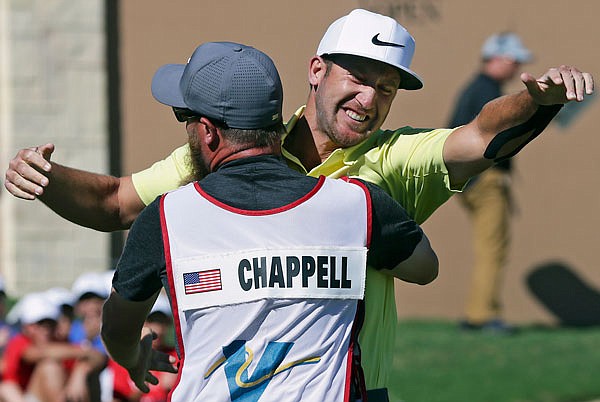 Kevin Chappell gets a hug from his caddy, Joe Greiner, after sinking a birdie putt on the 18th hole Sunday to win the Valero Texas Open in San Antonio.