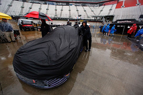 A crew team pushes a car through the pit area Sunday in Bristol, Tenn.