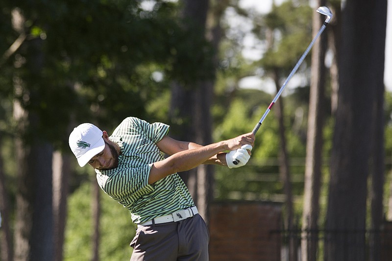 Thomas Rosenmueller of University of North Texas hits the ball Monday during the Conference USA golf tournament at Texarkana Country Club. Due to possible rain on Wednesday, the tournament scheduled more events Monday and will finish today.