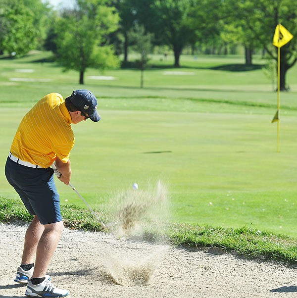 Helias golfer Dalton Roark hits out of the sand trap on the eighth hole Monday in the Capital City Classic at Meadow Lake Acres Country Club.