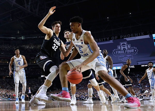 In this April 3 file photo, North Carolina forward Tony Bradley (right) drives past Gonzaga forward Zach Collins during the second half in the championship game of the NCAA Tournament in Glendale, Ariz. Bradley is among the players who wants to test his NBA draft stock before deciding whether to hire an agent or return to school.