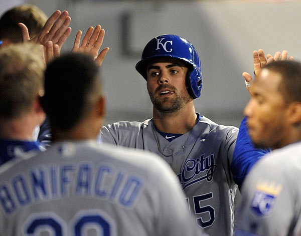 Royals second baseman Whit Merrifield celebrates with teammates in the dugout after scoring on a Mike Moustakas double during the third inning of Monday night's game against the White Sox in Chicago.