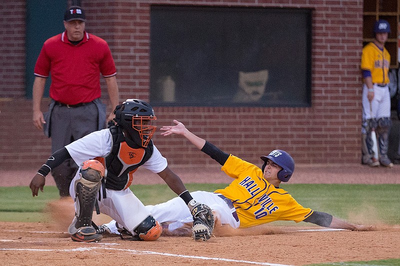 Texas High catcher Jordan Thomas makes the tag on Hallsville's Masen Oxsheer on Tuesday during the fourth inning  at Tiger Field in Texarkana, Texas.