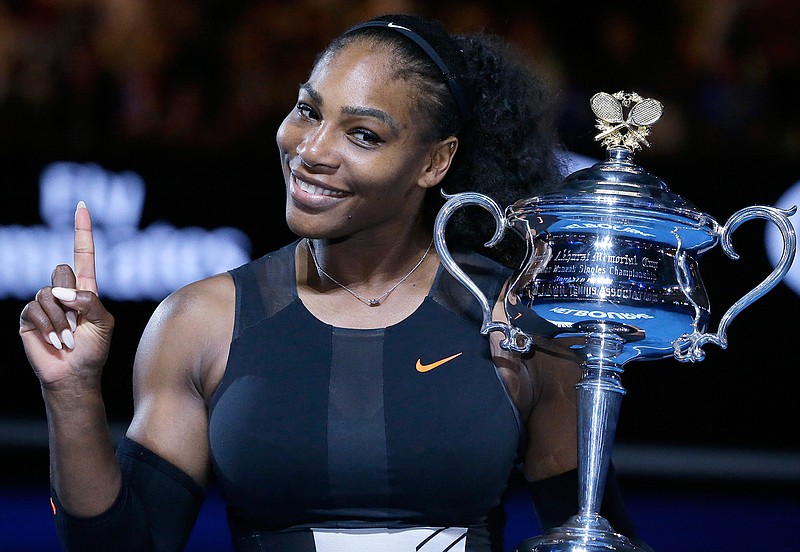 In this Jan. 28, 2017, file photo, Serena Williams holds up a finger and her trophy after defeating her sister, Venus, in the women's singles final at the Australian Open tennis championships in Melbourne, Australia. Serena Williams is briefly back at No. 1 in the WTA rankings, despite not having played a match since January, and with plans to take the rest of 2017 off because she is expecting a baby. Thanks to a calendar quirk, Williams moved up one spot from No. 2, swapping places with Angelique Kerber.