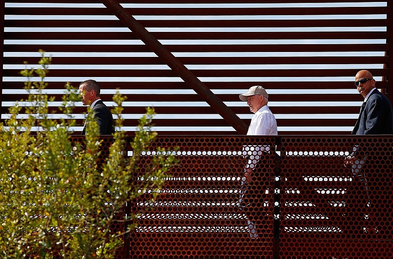 In this April 11, 2017, file photo, Attorney General Jeff Sessions, center, tours the U.S.-Mexico border with border officials in Nogales, Ariz. A courthouse on the border in Texas is serving as a model for the kind of tough immigration enforcement advocated by President Donald Trump. "This is a new era. This is the Trump era," Sessions said during a visit to the border in Nogales, Ariz., this month.