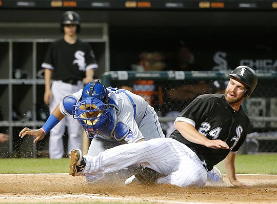 Royals catcher Salvador Perez, tags out Matt Davidson of the White Sox at the plate during Tuesday night's game in Chicago.