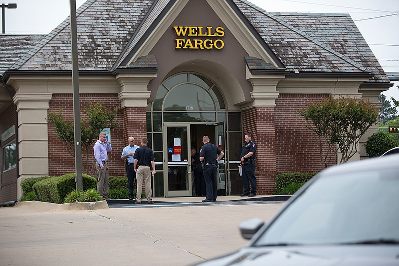 Texarkana, Texas, police conduct their investigation Wednesday after Wells Fargo Bank, at the corner of New Boston and Summerhill roads, was robbed by a masked man with a handgun. The robber left on a bicycle before discarding the bike and getting in an SUV.