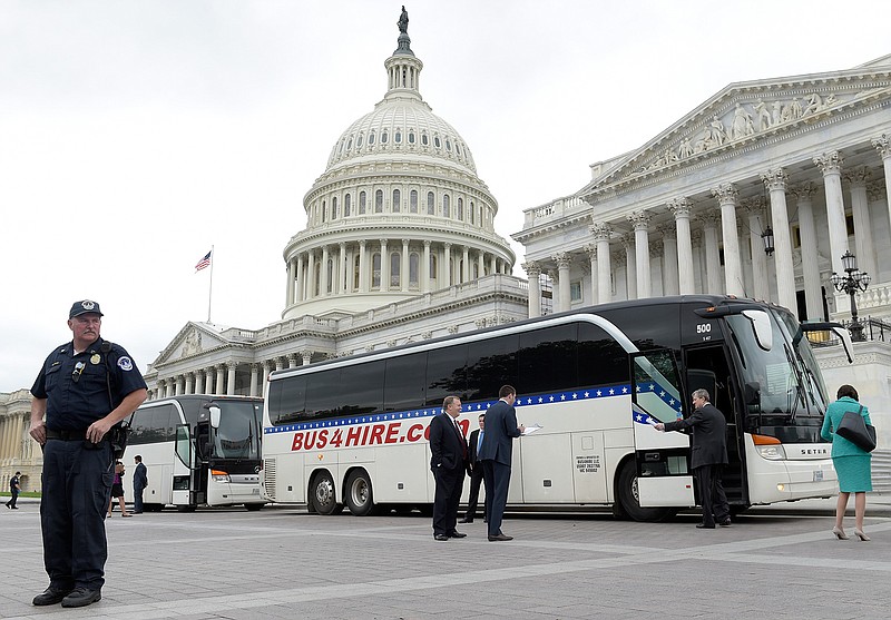 Sen. John Kennedy, R-La., second from right, boards a bus on Capitol Hill in Washington, Wednesday, April 26, 2017, heading to the White House with other Senators to get a briefing on North Korea. 