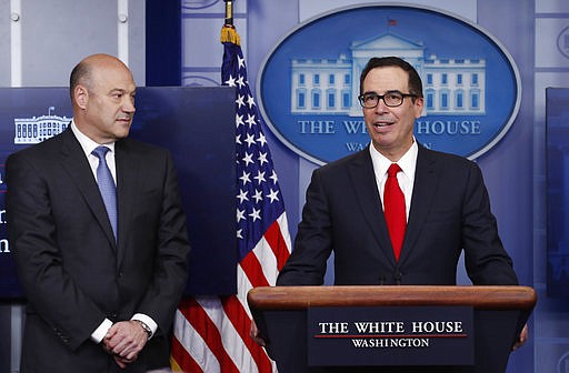 Treasury Secretary Steven Mnuchin, joined by National Economic Director Gary Cohn, speaks in the briefing room of the White House in Washington, Wednesday, April 26, 2017. President Donald Trump is proposing dramatically reducing the taxes paid by corporations big and small in an overhaul his administration says will spur economic growth and bring jobs and prosperity to the middle class. 