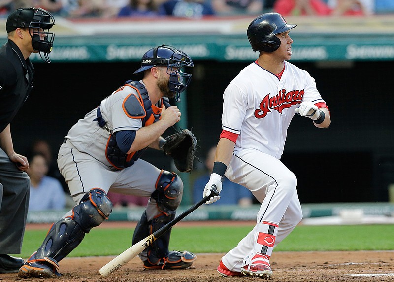 Cleveland Indians' Michael Brantley watches his two-run single off Houston Astros starting pitcher Lance McCullers Jr. in the fifth inning of a baseball game, Wednesday, April 26, 2017, in Cleveland. The Astros catcher is Brian McCann. 