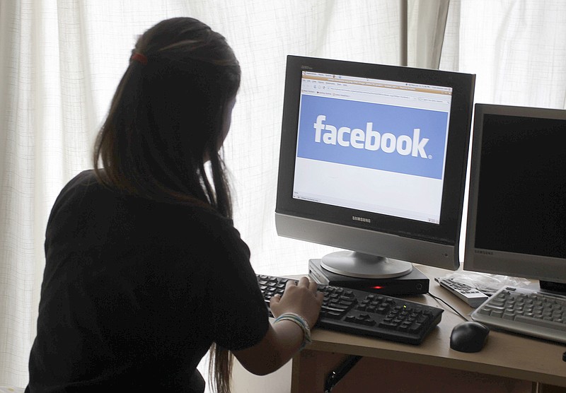A girl looks at Facebook on her computer in Palo Alto, California. 