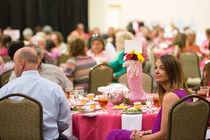 Kim Keith, previous chairwoman for Race for a Cure, and others listen as the 2017 Komen Grant Recipients are announced Thursday at the Race for a Cure Survivor Luncheon at the Texarkana Convention Center.