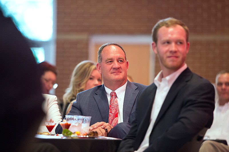 During the Texarkana, Ark., School District's Distinguished Alumni dinner Thursday, Arkansas Sen. Jimmy Hickey Jr. listens as former Arkansas Rep. Prissy Hickerson talks about some of the causes that Hickey has championed while in office. Hickey graduated from Arkansas High in 1985.