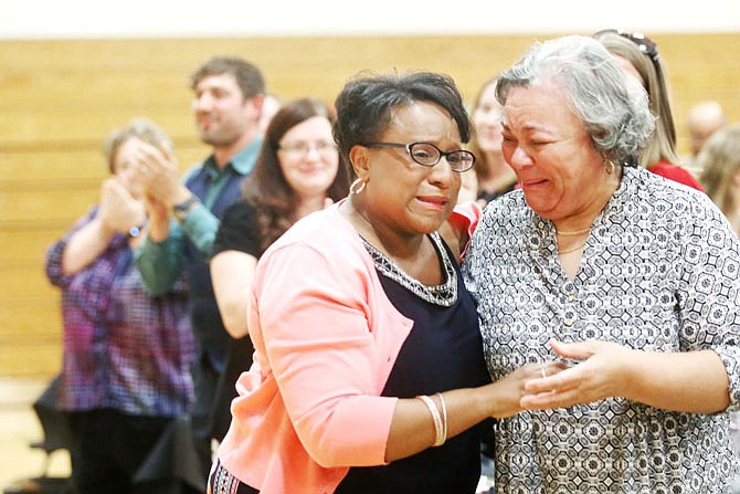 Rhonda Allen, left, reacts to being named 2017 Teacher of the Year as her mother, Saundra Allen, right, celebrates with her Thursday during the annual Jefferson City Public School banquet at Lewis and Clark Middle School. 