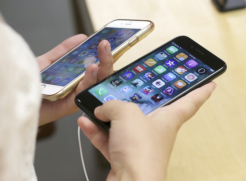 A new iPhone 7, right, is compared with an iPhone 6 in September 2016 at the Apple Store in Chicago. Qualcomm said Apple's refusal to pay royalties related to technology used in smartphones will take a big bite out of its profit and revenue.