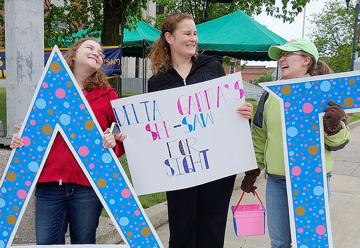 Delta Gamma members, from left, Samantha Keizer, Rachel Bradley and Emily Richey raise money Thursday for their foundation's initiative.