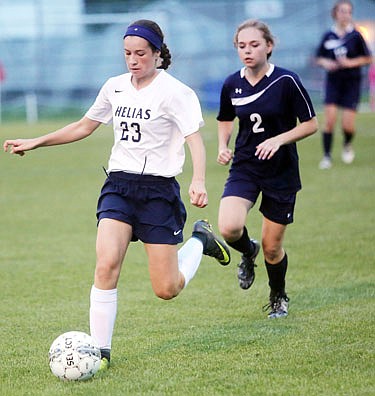 Reese Hamilton of Helias controls the ball during Thursday night's game against Father Tolton at the 179 Soccer Park.