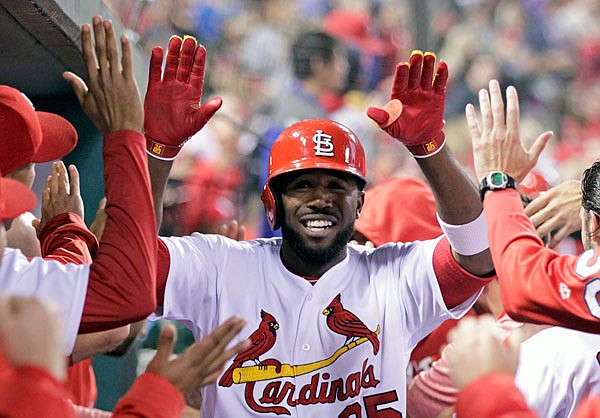 Dexter Fowler celebrates with Cardinals teammates after hitting a two-run home run in the third inning of Friday night's game against the Reds at Busch Stadium.