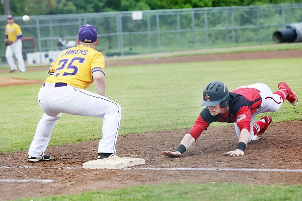 Tyler Bise of the Jays dives back into first base while Conner Loge of Camdenton waits for a pickoff throw during Friday's game at Vivion Field.