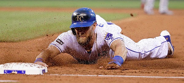 Alex Gordon of the Royals dives safely back to first after Alcides Escobar lined out during the second inning of Friday's game against the Twins at Kauffman Stadium.