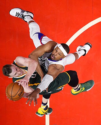 Gordon Hayward of the Jazz shoots as Paul Pierce of the Clippers defends Sunday in Los Angeles.