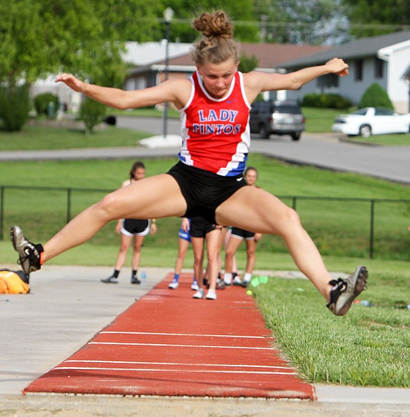 California senior Ellie Wirts glances down before landing during the long jump.