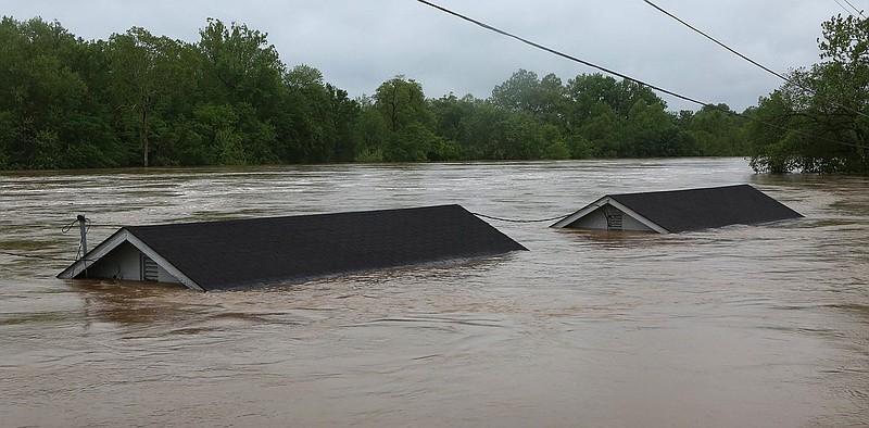 Two rental houses look underwater next to the Meramec River on Opps Lane in Fenton, Mo., Wednesday, May 3, 2017. Heavy rains have swollen many rivers to record levels in parts of Missouri, Illinois, Oklahoma and Arkansas. Five deaths have been blamed on flooding in Missouri, while hundreds of people have been displaced and thousands more are potentially in harm's way.