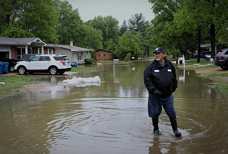 Walter Northcutt walks along Boeing Drive as he checks on his neighbors efforts to keep floodwater from Meramec River out of their homes on Thursday, May 4, 2017.