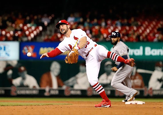 Cardinals second baseman Greg Garcia makes an off-balance throw to first during the sixth inning of Thursday night's game against the Brewers at Busch Stadium.