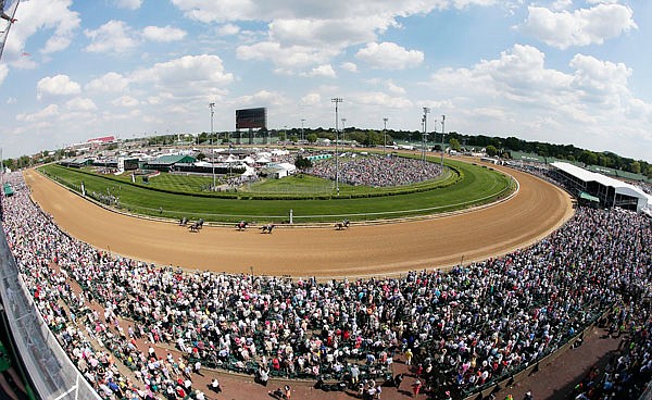 In this May 2, 2015, file photo, taken with a fisheye lens, fans watch a race before the 141st running of the Kentucky Derby at Churchill Downs in Louisville, Ky.