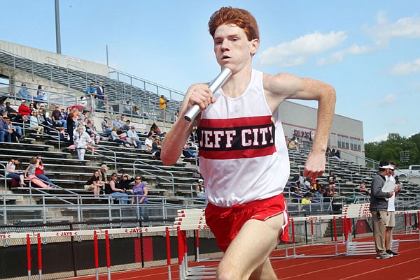 Cole Bieseymeyer of Jefferson City carries the baton during the boys 4x800-meter relay Friday at Licklider Track.