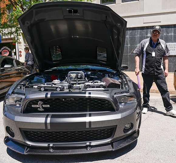 Mustang enthusiast Dennis Griswold dusts the body of his 2011 Super Snake Mustang on display in downtown Jefferson City Saturday, May 6, 2017. "I think they're special cars," said Griswold, "but this one is very special because my wife bought it for me as a retirement gift."

