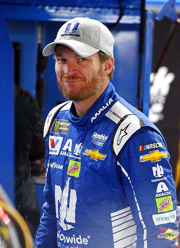 Dale Earnhardt Jr. (88) smiles while getting ready in the garage during practice for the NASCAR Cup Series auto race at Talladega Superspeedway, Friday, May 5, 2017, in Talladega, Ala. 