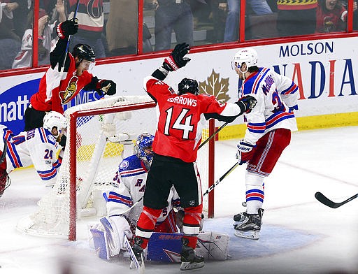 Ottawa Senators center Kyle Turris, top left, and Alex Burrows (14) celebrate after Turris scored the game-winning goal during overtime against the New York Rangers in Game 5 in the second round of the NHL hockey Stanley Cup playoffs in Ottawa on Saturday, May 6, 2017. The Senators won 5-4 in overtime. (Sean Kilpatrick/The Canadian Press via AP)