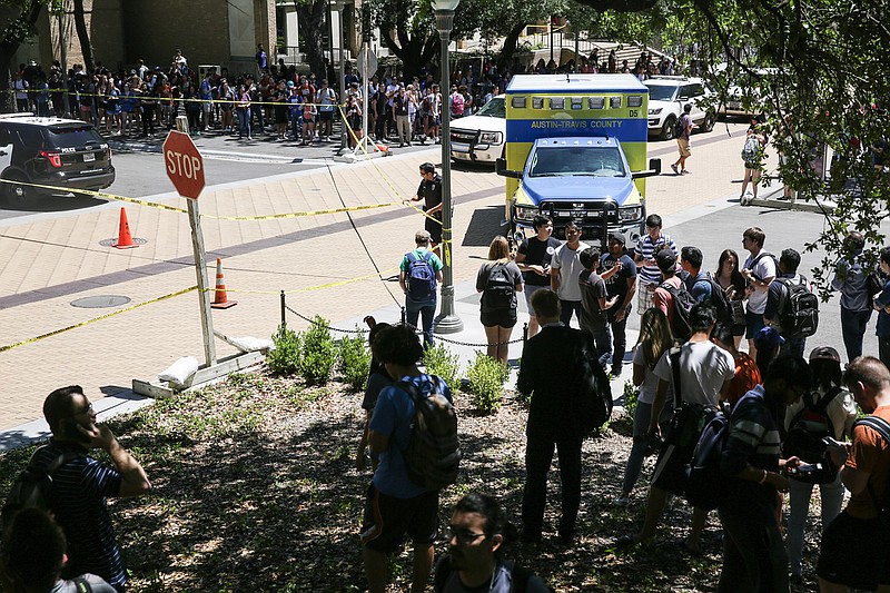 In this Monday, May, 1, 2017, file photo, law enforcement officers secure the scene after a fatal stabbing attack on the University of Texas campus. The nightmare scenario of a knife wielding attacker put Texas' college campus concealed carry law to the test but provided no real conclusion. Both gun rights and gun control activists insist the attack bolstered their argument that guns do or don't belong on campus. 