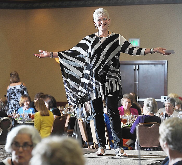 Paula Troncoso stops on the runway Monday to model her outfit during the Cole County Historical Society Fashion Show and Luncheon held at the Capitol Plaza Hotel. The runway was a new addition to this year's show.