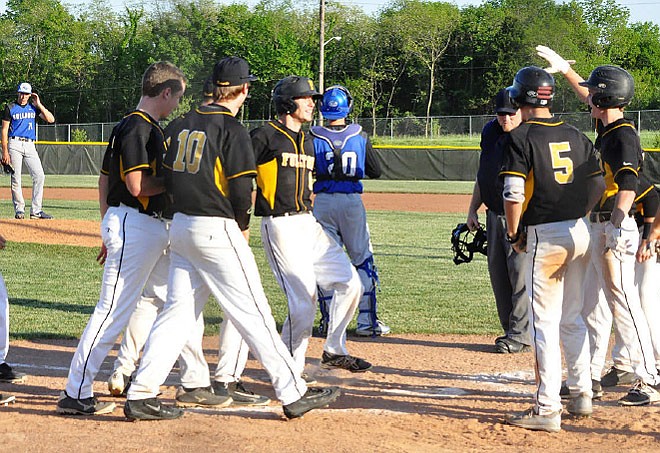 Fulton senior center fielder Alec Fleetwood (center) gets ready to touch home plate after hitting a three-run home run in the bottom of the sixth inning against the state-ranked South Callaway Bulldogs on Monday night, May 8, 2017 at the high school athletic complex. Fleetwood's homer capped off a five-run rally in the inning as Fulton downed South Callaway 8-4.