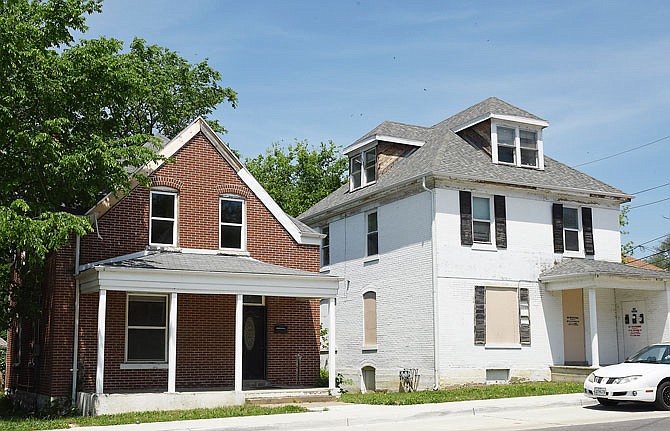The houses at 410 Lafayette, left, and 408 Lafayette St. are on a list of homes to possibly be demolished to make way for a public park or civic space near the East McCarty Greenway entrance. 
