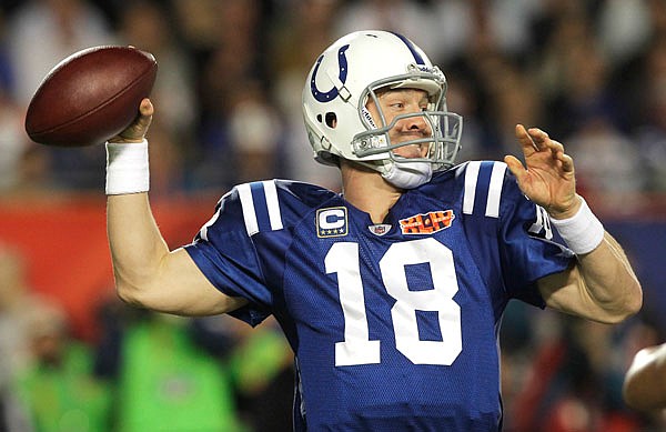 In this Feb. 7, 2010, file photo, Colts quarterback Peyton Manning passes against the Saints during Super Bowl XLIV in Miami. Manning will become the first Indianapolis Colts player to have his jersey retired during a two-day celebration of his career this fall.