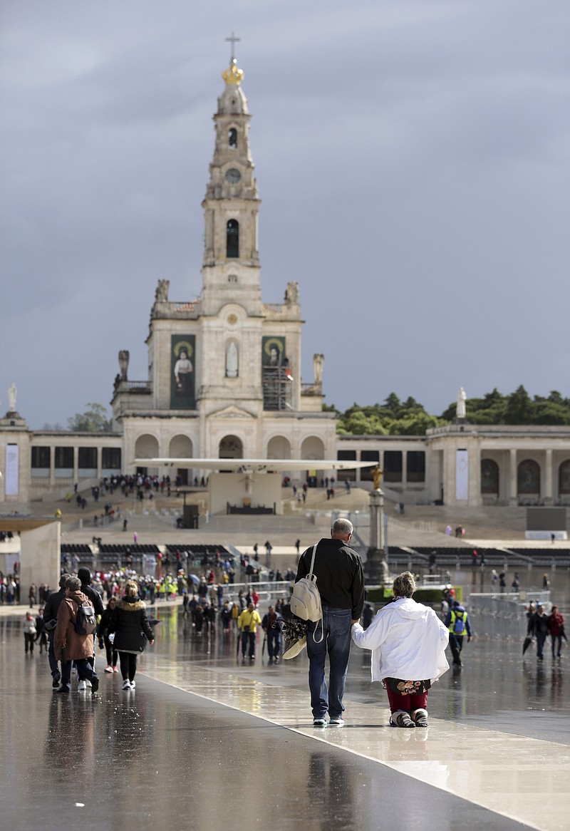 A woman walks on her knees paying penance at the Fatima Sanctuary, Thursday, May 11 2017, in Fatima, Portugal. Pope Francis is visiting the Fatima shrine on May 12 and 13 to canonize two Portuguese shepherd children whose "visions" of the Virgin Mary 100 years ago turned the sleepy farming town of Fatima into a major Catholic pilgrimage site.