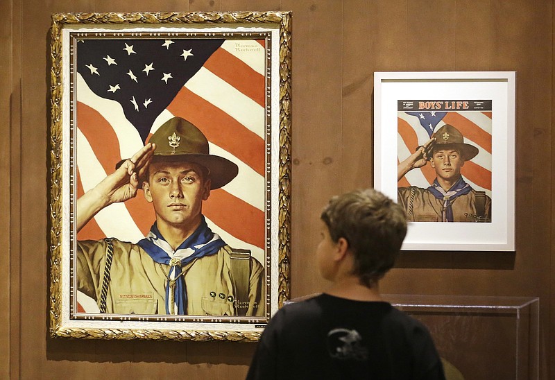In this July 22, 2013, file photo, an 11-year-old boy looks over a Boy Scout-themed Norman Rockwell exhibition at the Church History Museum in Salt Lake City, Utah.