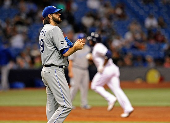Royals starter Jason Hammel rubs up a new baseball after giving up a solo home run to Rickie Weeks Jr. of the Rays during the third inning of Wednesday night's game in St. Petersburg, Fla.