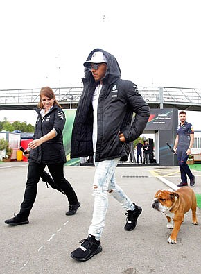 Lewis Hamilton walks with his dog by the paddock Thursday at the Barcelona Catalunya racetrack in Montmelo, just outside Barcelona, Spain.