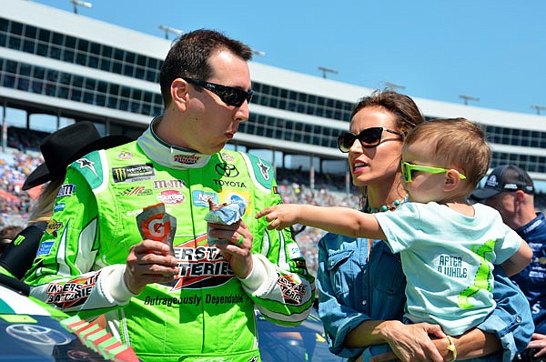 Kyle Busch jokes with his son, Brexton, as he talks with his wife, Samantha, on pit road before the NASCAR Cup Series race last month in Fort Worth, Texas.
