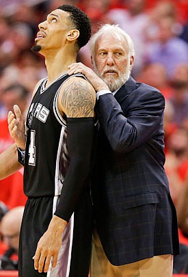 Spurs coach Gregg Popovich calms down Danny Green after Green was called for a technical foul during the second half of Thursday night's game against the Rockets in Houston.